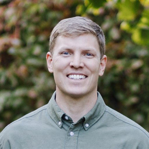 Professional portrait of Tyler Konesky smiling outdoors